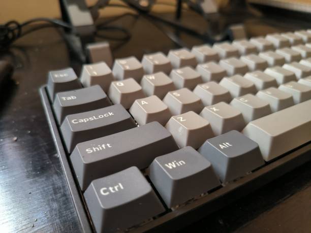 istock Photo a black keyboard on a wooden table 1489984512