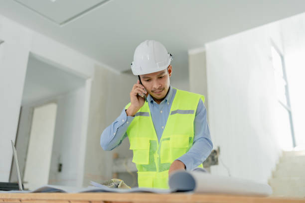 istock multi ethnic engineer brainstorming and measuring for cost estimating on blueprint and floor plan drawings about design architectural and engineering for houses and buildings 1489984704