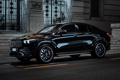 Ancona, Italy – November 11, 2022: A black Mercedes Benz GLE 53 AMG parked in a desolate street at night