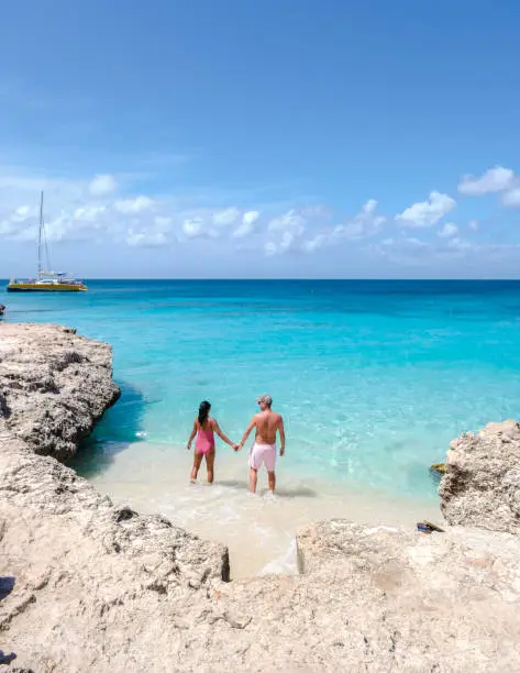 Tres Trapi Steps Triple Steps Beach, Aruba, Popular beach among locals and tourists for diving and snorkeling, couple man and woman in a crystal clear ocean in the Caribbean