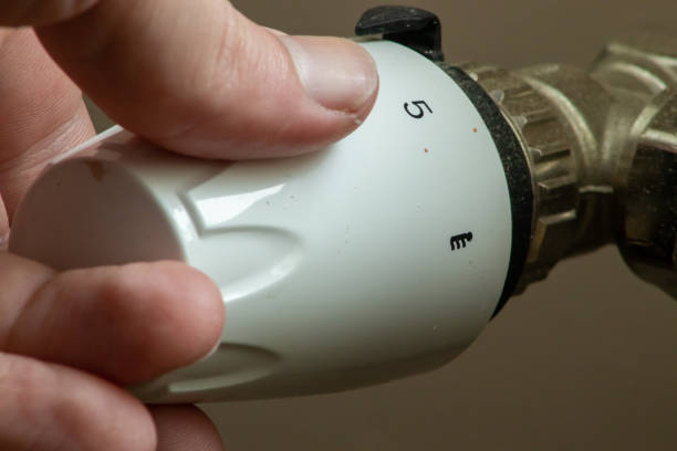 istock Close up hand adjusting heating temperature. Reducing heating cost in crisis. War in Ukraine. Energy crisis. regulating temperature knob concept 1489988036