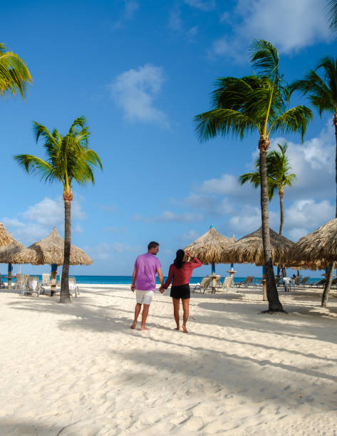 istock Palm Beach Aruba Caribbean, white long sandy beach with palm trees at Aruba Antilles 1489988043