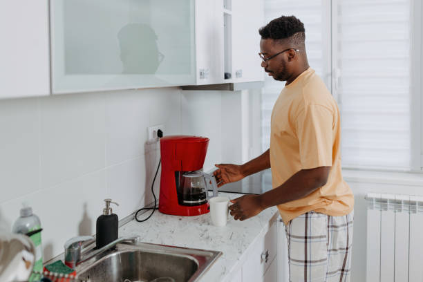 istock African American Man Makes Coffee on Espresso Machine 1489992066