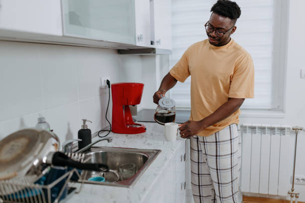 istock African American Man Brews Morning Coffee on Espresso Machine 1489992085