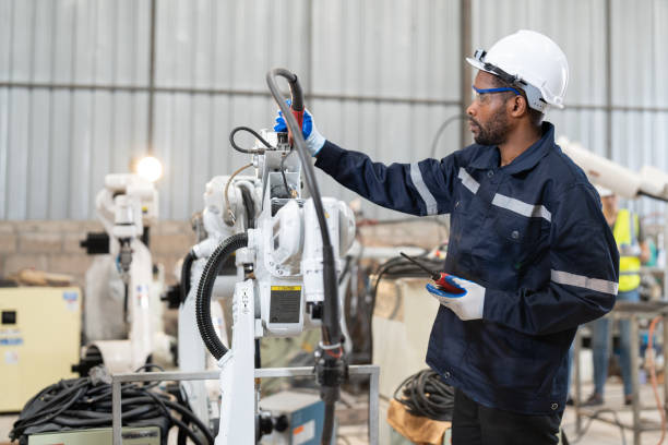 istock Male automation engineer testing and repairing robot arm welding machine in an industrial factory 1489992162