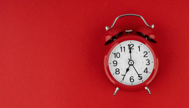 istock Red alarm clock on a red background. Top view. 1489992929