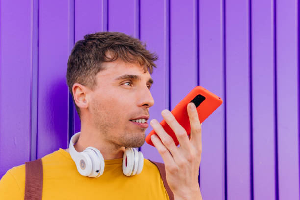 istock Hispanic person sending a voice command from his smartphone.Social networks and mobile application. 1489993942