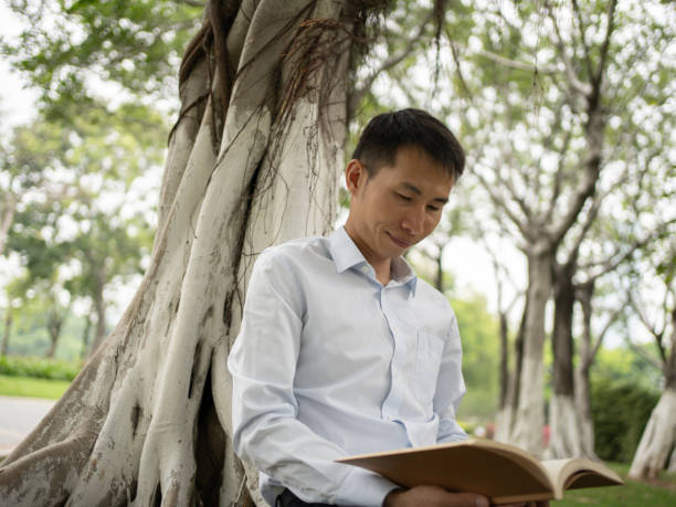 istock man enjoying reading outdoors 1490001068