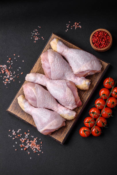istock Raw chicken legs with salt, spices and herbs 1490001506