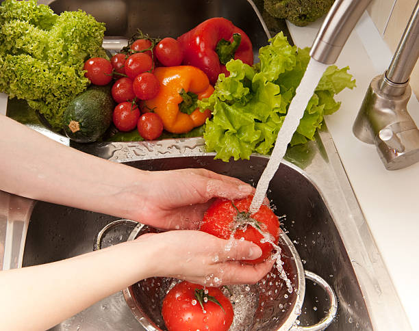 istock Hands washing fresh vegetables at the sink 149000346