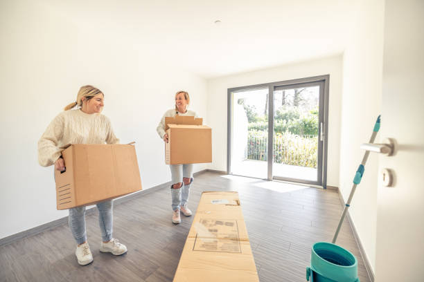 Two female friends moving house together