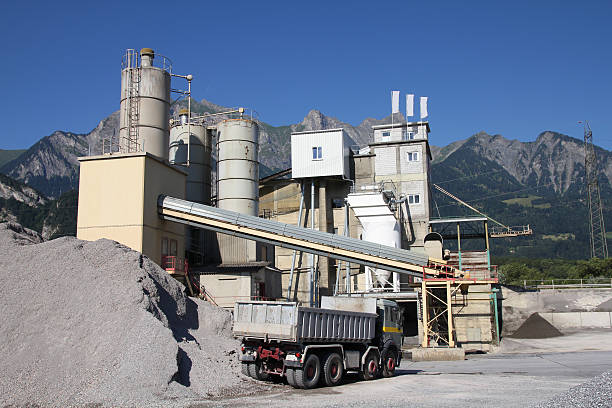 Cement production Cement factory with Alps in the background. Canton of St. Gallen, Switzerland. cement factory stock pictures, royalty-free photos & images