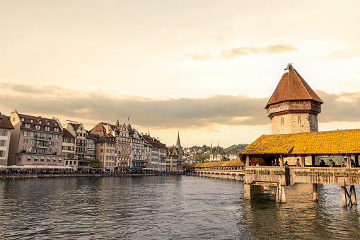 A beautiful scenery of the city skyline in different atmosphere.\nCute cities in Switzerland, old town view.\nAmazing view of Lucerne cityscape at sunset, Switzerland