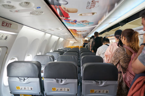 Passengers standing in the aisle at Nok Air Boeing 737-800 after landing stock photo