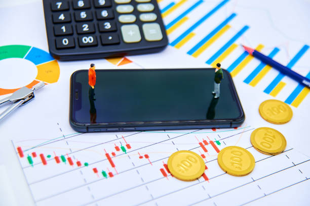 istock Two people standing on their phones trading 1490019372