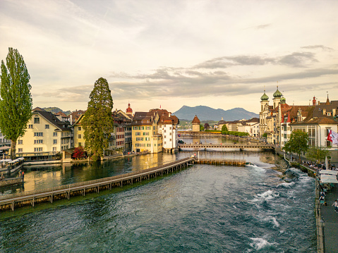 A beautiful scenery of the city skyline in different atmosphere.\nCute cities in Switzerland, old town view.\nAmazing view of Lucerne cityscape at sunset, Switzerland