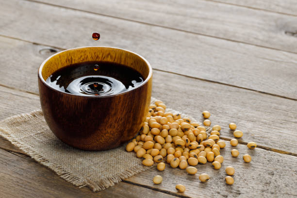 istock soy sauce in bowl with falling drops and dry soybeans on table 1490021340
