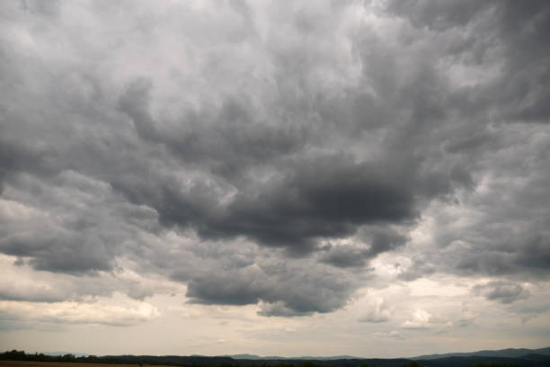 istock Big thick gray clouds in a stormy sky. 1490030017
