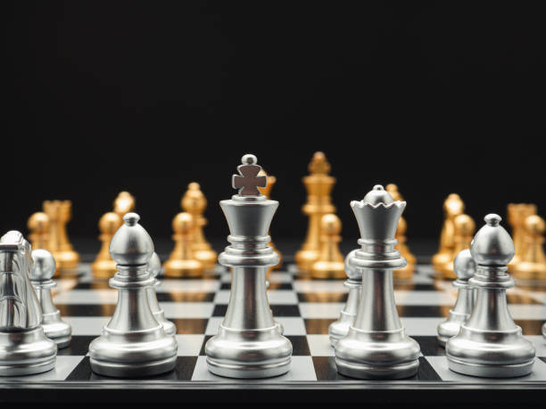 istock Chess pieces on board game planning and competition on black background 1490031395