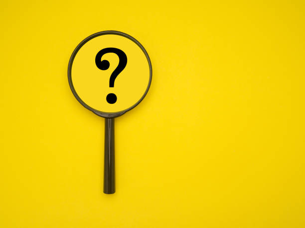 istock Top view of a magnifying glass with question mark isolated on a yellow background 1490031778