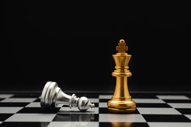 istock Chess pieces on board game planning and competition on black background 1490033997