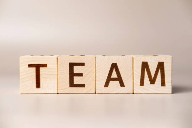 istock The word TEAM on wooden cubes on a beige neutral studio background. Copy Space. Written. Text words matter. Conceptual Photo. Career symbol. The concept of volume increase make business grow. 1490045119