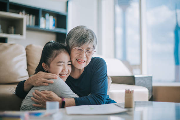 거실에서 손녀를 껴안고 있는 행복한 중국 할머니 - chinese ethnicity family togetherness happiness 뉴스 사진 이미지