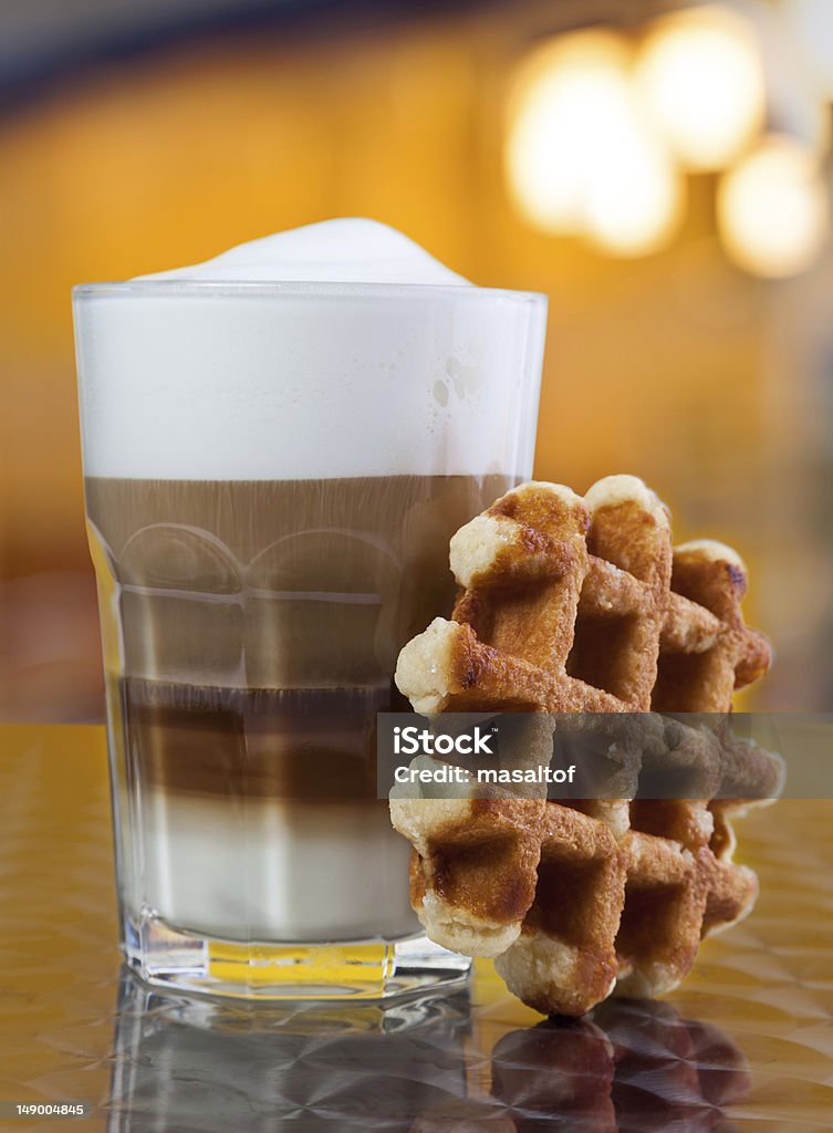 Cafe Coffee - Latte Cappuccino in a tall glass Cafe Latte in a glass with Waffle on Table Beige Stock Photo