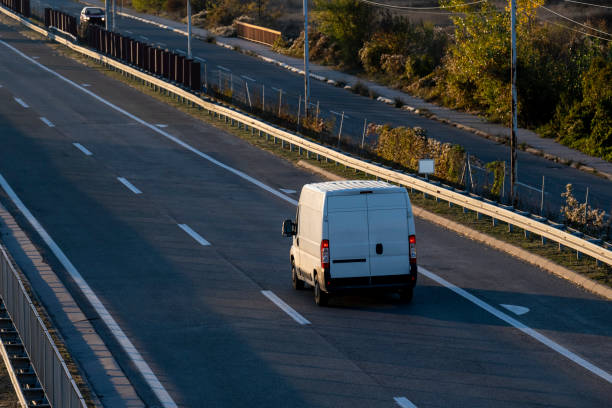 istock White delivery van on the highway. White modern delivery small shipment cargo courier van moving fast on motorway road to city urban suburb. The business distribution and logistics express service. 1490048947