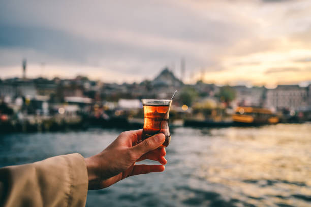 Woman holding traditional Turkish tea in Istanbul, Turkey