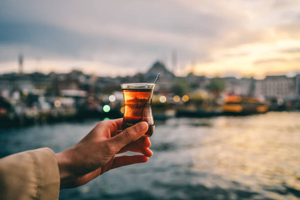 Woman holding traditional Turkish tea in Istanbul, Turkey