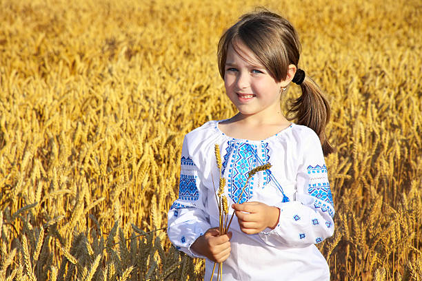 istock small rural girl on wheat field 149005618
