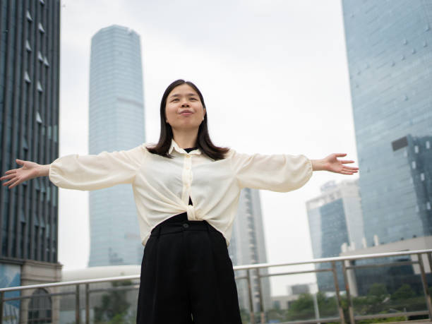 istock woman relaxing outside tall building 1490058801