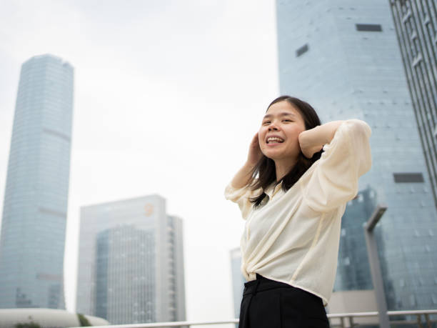 istock woman relaxing outside office building 1490059073