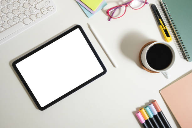 istock Digital tablet with blank screen, coffee cup, glasses and stationery on white working desk. 1490063624