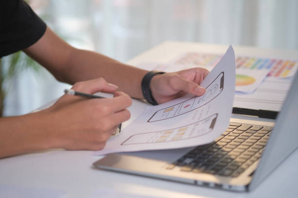 istock Close up  ui designer planning application development for web mobile phone at desk. 1490065817