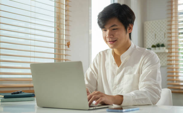 istock Handsome business man entrepreneur looking at screen working in internet , typing email on laptop computer. 1490067106