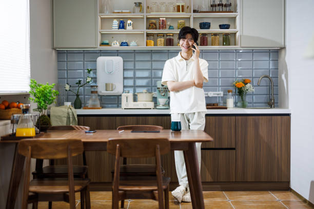 istock Asian men making phone calls in the kitchen 1490067426