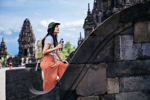 Asian tourist woman while traveling in Prambanan temple, Yogyakarta, Indonesia