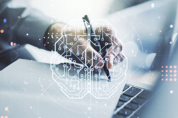 istock Creative artificial Intelligence concept with human brain hologram and hand writing in notebook on background with laptop. Multiexposure 1490070394
