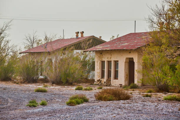 Image of Abandoned ghost town structures in desert with sandstorm