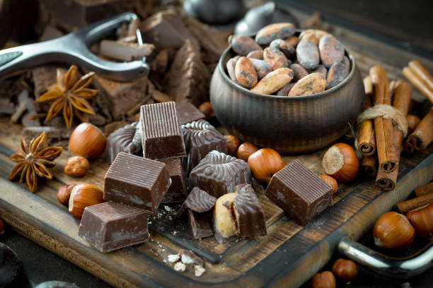 istock Chocolate, nuts, cocoa beans in a composition on an old background. 1490074237