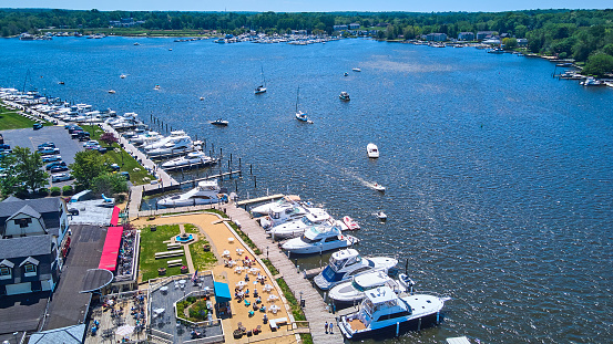Image of Aerial of lake town with docks filled with boats