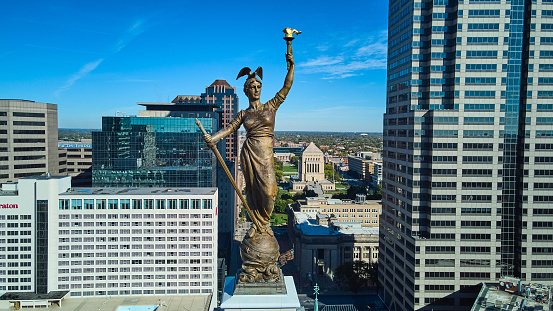 Image of Aerial of Soldiers & Sailors Monument statue at top straight on with Indianapolis downtown in background