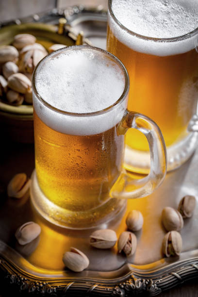 istock Light beer in a glass on a wooden background. 1490077124