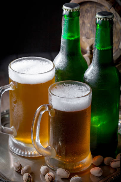 istock Light beer in a glass on a wooden background. 1490077126