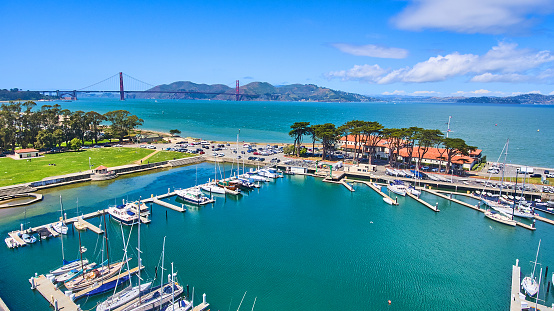 Image of Aerial view of yacht harbor in San Francisco with Golden Gate Bridge in distance