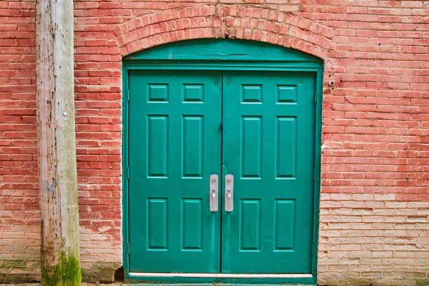 istock Alley double green door with red brick 1490077321