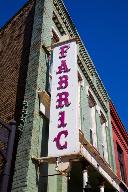 istock Antiquated sign saying fabric on a downtown shopfront 1490077778