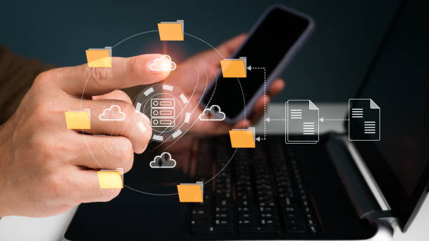 istock An IT specialist is configuring a Document Management System (DMS) on a laptop at the office. program for archiving company files 1490078618